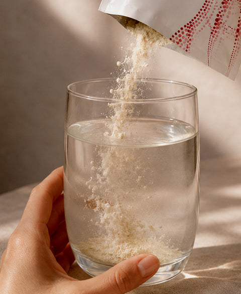 Kollagen-Pulver aus einem PREXLETICS Sachet wird in ein Glas Wasser gegeben